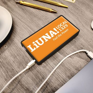 LiUNA! Local 1329 branded portable power bank charging a phone