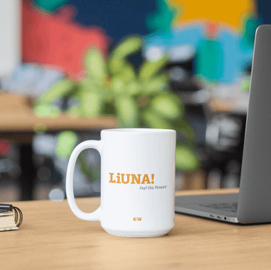 White LiUNA! branded coffee mug on a desk