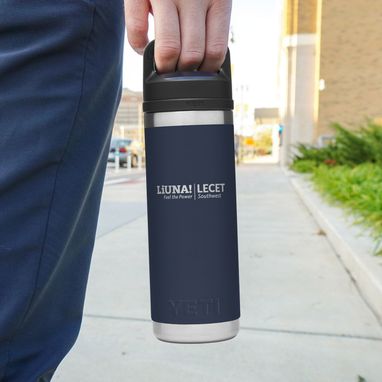 Navy LiUNA! LECET branded YETI tumbler held outdoors