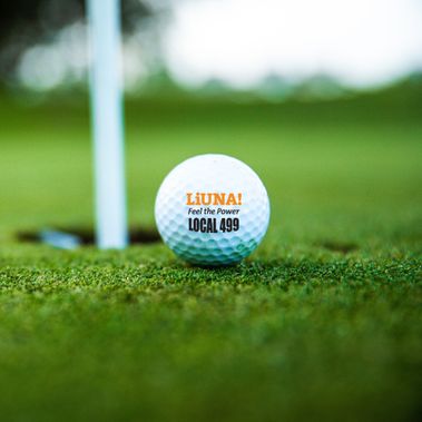 LiUNA! Local 499 branded golf ball next to the pin
